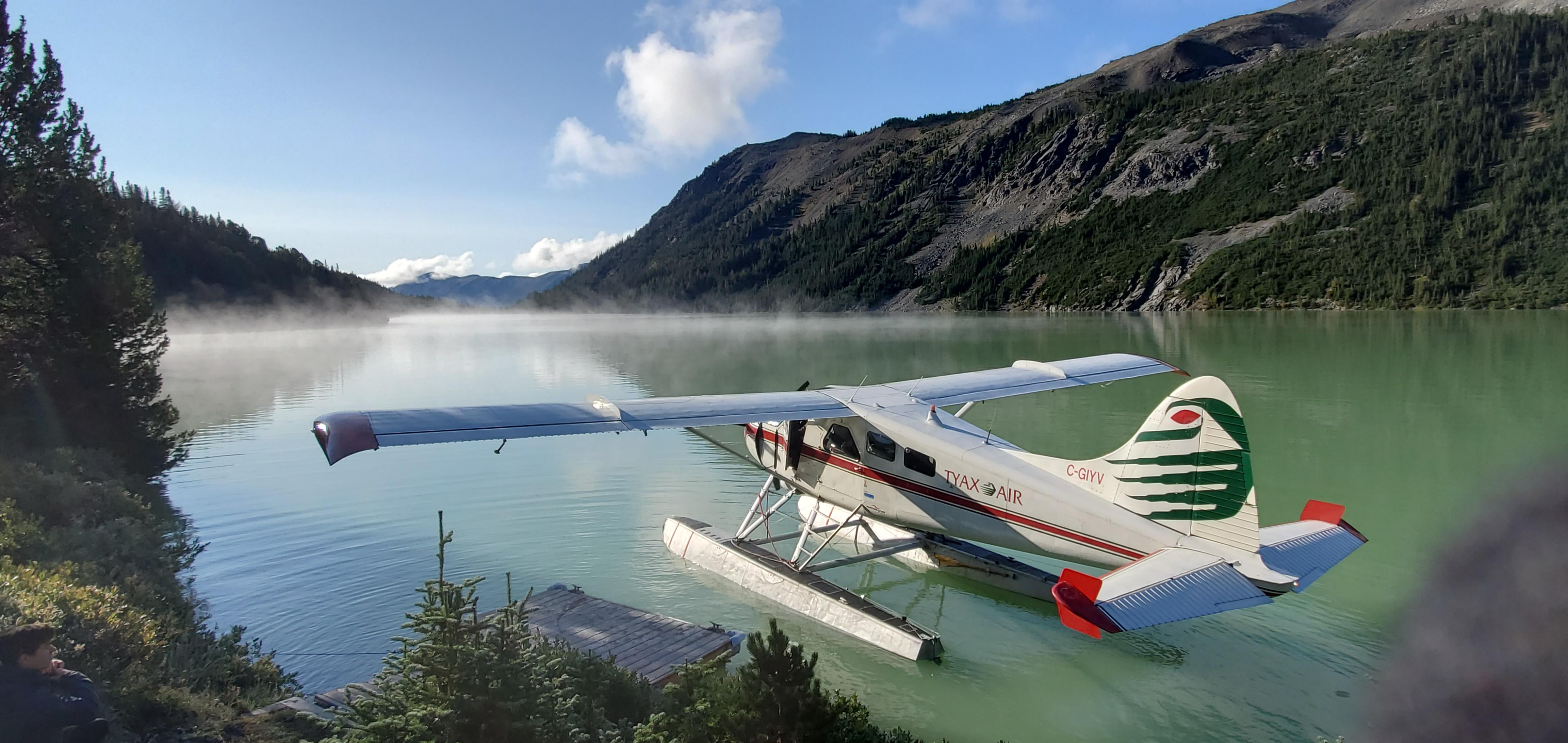 Float plane leaving on Warner Lake with morning mist